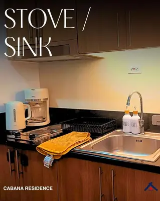 a kitchen with a sink and a counter top at Cabana Residence at Shore 3 - MOA Complex in Manila