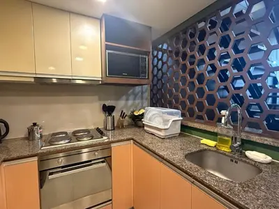 a kitchen with a sink and a stove at Modern Loft in Newport City - 2BR and 2BA in Manila