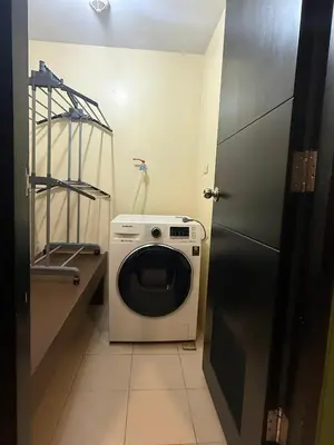 a washer and dryer in a small bathroom at Modern Loft in Newport City - 2BR and 2BA in Manila