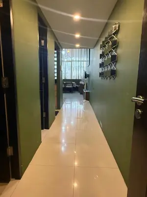a hallway with green walls and a long white floor at Modern Loft in Newport City - 2BR and 2BA in Manila
