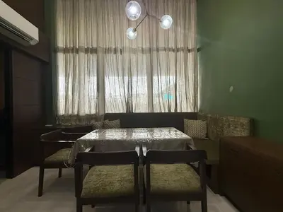 a dining room with a table and chairs and a window at Modern Loft in Newport City - 2BR and 2BA in Manila