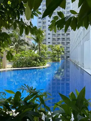 a swimming pool in the middle of a city with tall buildings at 1BR Romantic guest room at Shore Residences, Pasay Near MOA & Airport in Manila