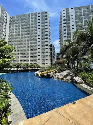 a large swimming pool in front of a large building at 1BR Romantic guest room at Shore Residences, Pasay Near MOA & Airport in Manila