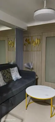 a living room with a couch and a table at 1BR Romantic guest room at Shore Residences, Pasay Near MOA & Airport in Manila