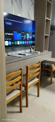 a tv sitting on top of a table with a chair at 1BR Romantic guest room at Shore Residences, Pasay Near MOA & Airport in Manila