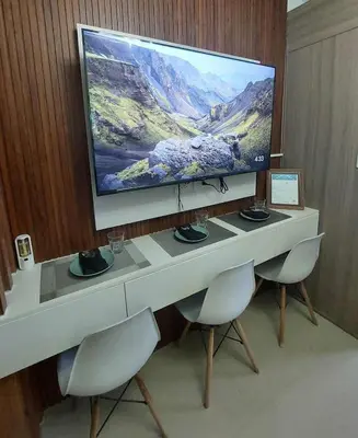 a large flat screen tv sitting on top of a desk at GB Travelers Rest at Shore 2 Residences in Manila