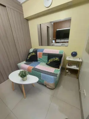 a living room with a couch and a table at GB Travelers Rest at Shore 2 Residences in Manila