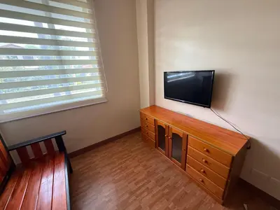 a flat screen tv sitting on top of a wooden dresser at Cypress 108 in Manggahan