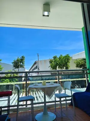 a table and chairs on a balcony with a view at MG Labels Property in Manila