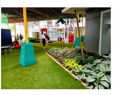 a person walking in a gym with a playground at Cozy 1BR Pioneer Woodland SM Light Boni Mandaluyong in Manila