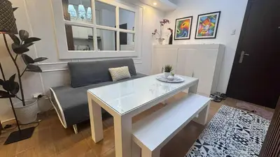 a living room with a table and a couch at Cozy 1BR Pioneer Woodland SM Light Boni Mandaluyong in Manila