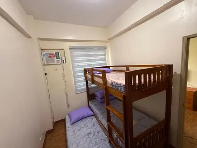 a bedroom with two bunk beds and a window at Manggahan General Trias Cavite in General Trias