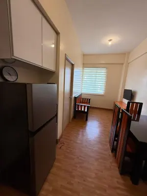 a kitchen with a refrigerator and a living room at Manggahan General Trias Cavite in General Trias