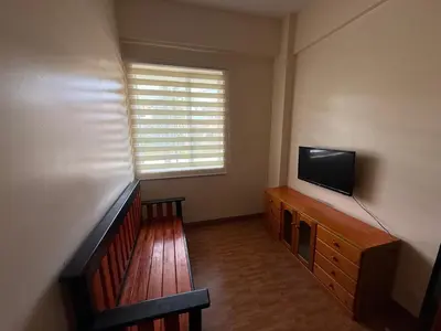 a living room with a television on a wooden dresser at Manggahan General Trias Cavite in General Trias