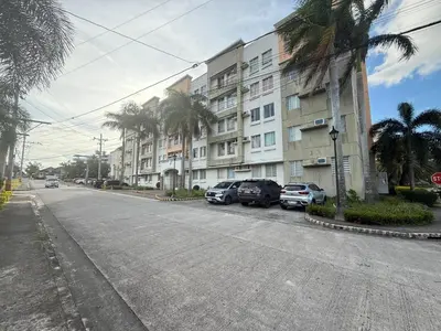 an empty street with cars parked in front of a building at Manggahan General Trias Cavite in General Trias