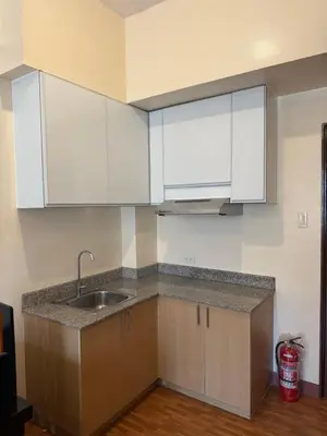a kitchen with white cabinets and a sink at Manggahan General Trias Cavite in General Trias