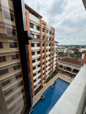 a view from the balcony of a building with a swimming pool at Paseo Verde at Real in Manila