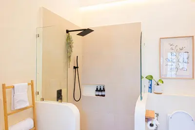 a bathroom with a shower and a toilet at Casa Dapyo in Sampong