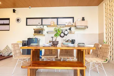 a dining room with a wooden table and chairs at Casa Dapyo in Sampong