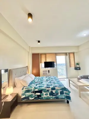 a bedroom with a bed and a tv in it at KIEL HOTEL - Manila Airport NAIA Terminal 3 in Manila