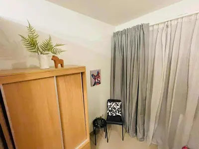 a room with a cabinet and a window with a plant at Jaiden & Blake Sweet Home in Manila