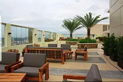 a patio with chairs and tables on a building at 1BR LaVerti Minalist affordable family staycation in Manila