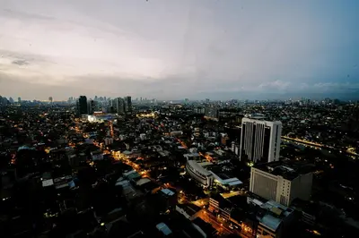 an aerial view of a city at night at Modern Studio with Balcony at Knightsbridge Residences, Poblacion Makati in Manila