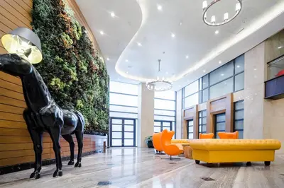 a lobby with a statue of a giraffe in a building at Modern Studio with Balcony at Knightsbridge Residences, Poblacion Makati in Manila