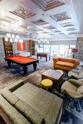 a living room with a pool table and couches at Modern Studio with Balcony at Knightsbridge Residences, Poblacion Makati in Manila