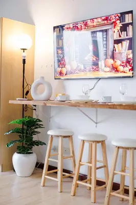 a room with three bar stools and a mirror at Modern Studio with Balcony at Knightsbridge Residences, Poblacion Makati in Manila