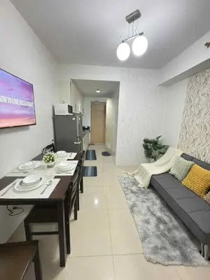 a living room with a couch and a table at 1Br Sea Residences affordable staycatiom in Manila