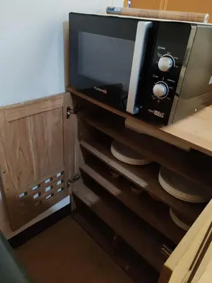 a microwave oven sitting on top of a cabinet at Cambridge cozy 2BR condo in San Andres