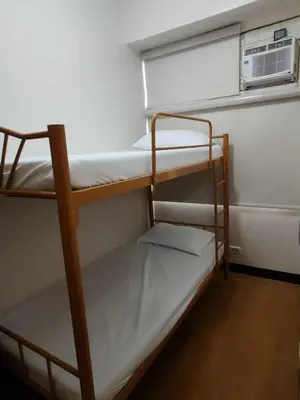 a bunk bed room with two bunk beds and a fan at Cambridge cozy 2BR condo in San Andres