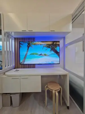 a room with a desk with a tv and a stool at Grace Residences Taguig in Manila