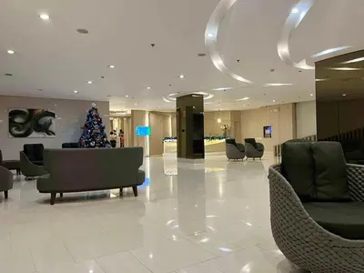 a christmas tree in the middle of a lobby at Grace Residences Taguig in Manila