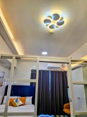 a room with two bunk beds and a light on the ceiling at Grace Residences Taguig in Manila