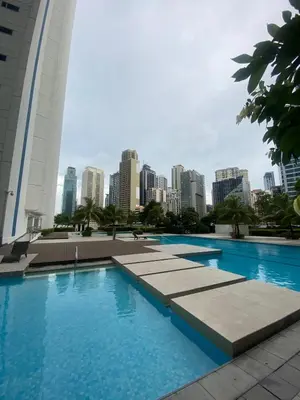 a swimming pool with a city skyline in the background at Jazz Tower A Cozy Room for 2 Adults in Manila
