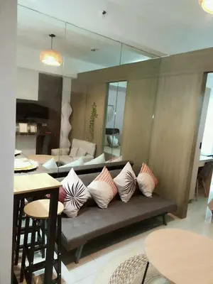 a living room with a couch with pillows on it at Boho Cove PH in Manila