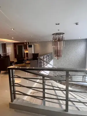 a lobby with a chandelier in a building at Boho Cove PH in Manila
