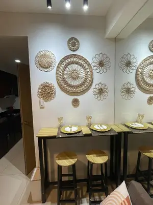 a room with a table and some plates on the wall at Boho Cove PH in Manila