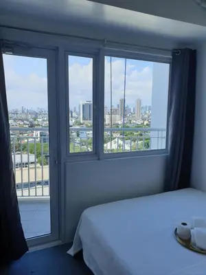 a bedroom with a window with a view of a city at Jazz Tower D Superb view with Queen Bed in Manila
