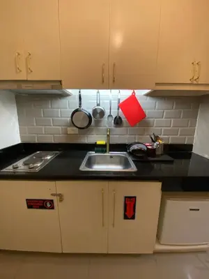 a kitchen with a sink and a counter top at Jazz Tower D Superb view with Queen Bed in Manila