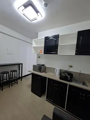 a kitchen with a sink and a counter top at Pod 520 in Manila