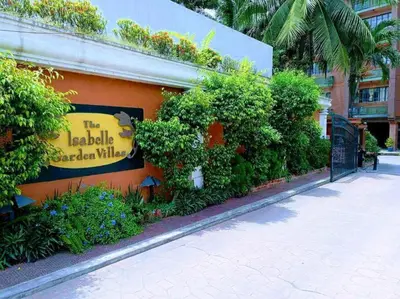 a sign on the side of a building with plants at Pod 520 in Manila