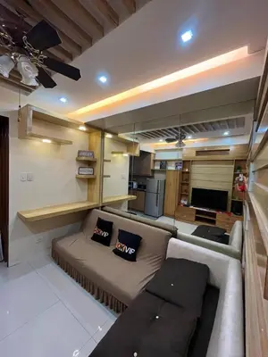 a living room with a couch and a kitchen at MOA Staycation Condotel in Manila