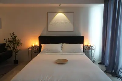 a bedroom with a white bed with a bowl on it at Bruné - Parañaque in Manila