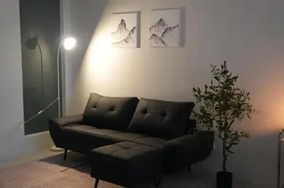 a living room with a couch and a plant at Bruné - Parañaque in Manila
