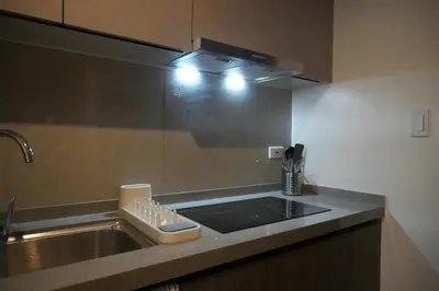 a kitchen with a sink and a counter top at Bruné - Parañaque in Manila