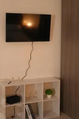 a flat screen tv hanging on a wall at Bruné - Parañaque in Manila