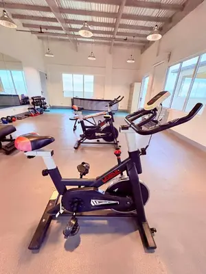 a gym with several exercise bikes in a room at Minimalist Condo near NAIA Free Netflix Pool Balcony in Manila